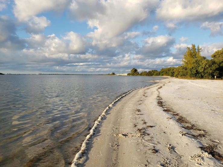 beach covered in sand with low water levels