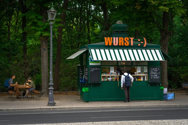 a person stands near an open food stand