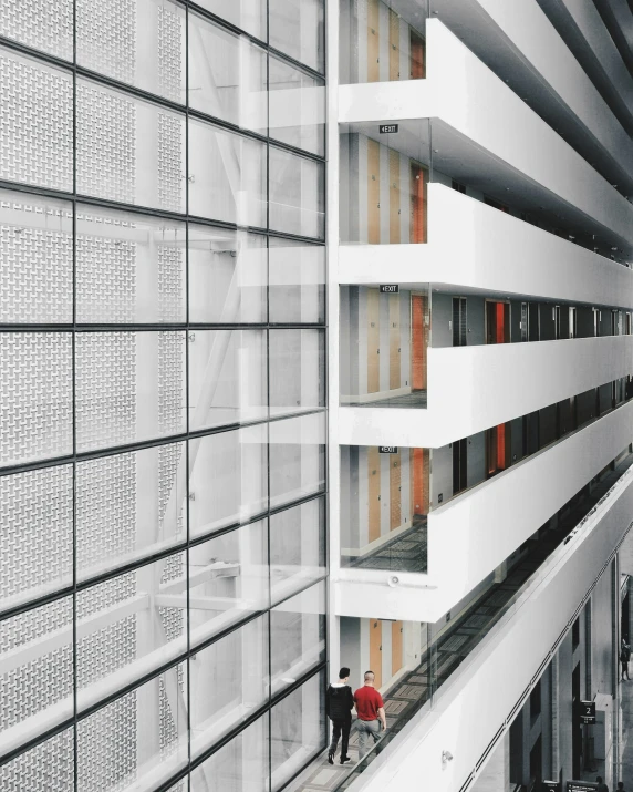 people in the distance inside a building looking into another