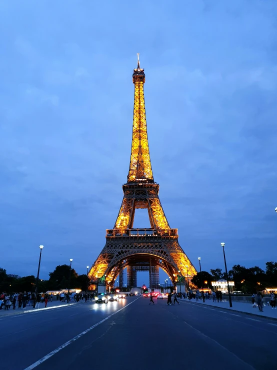 the eiffel tower is illuminated at night in the city