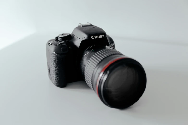 a canon camera and lens with the lens cap off