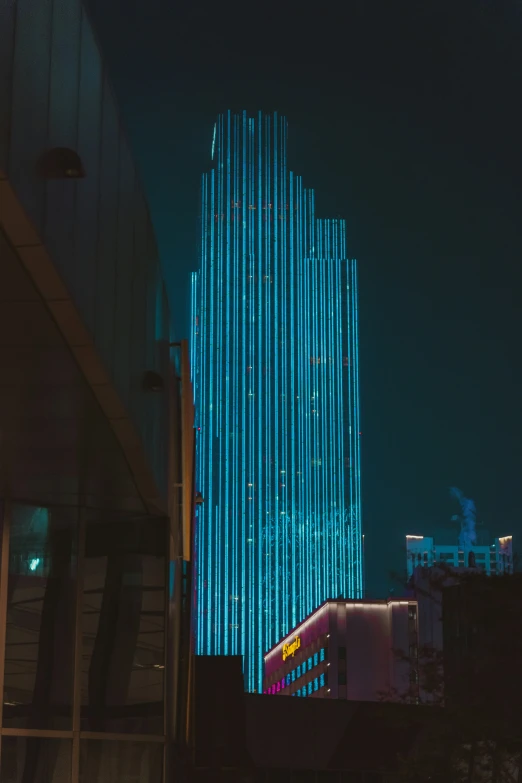 a large tall building with neon blue lights