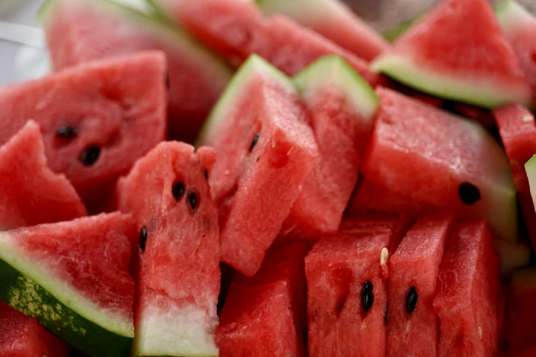 there are watermelon cut into slices and arranged on a plate