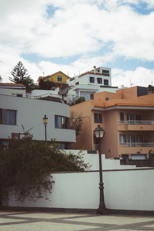 a street lamp stands in front of buildings