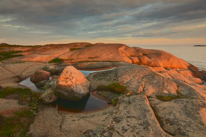 the sun is setting over a small body of water