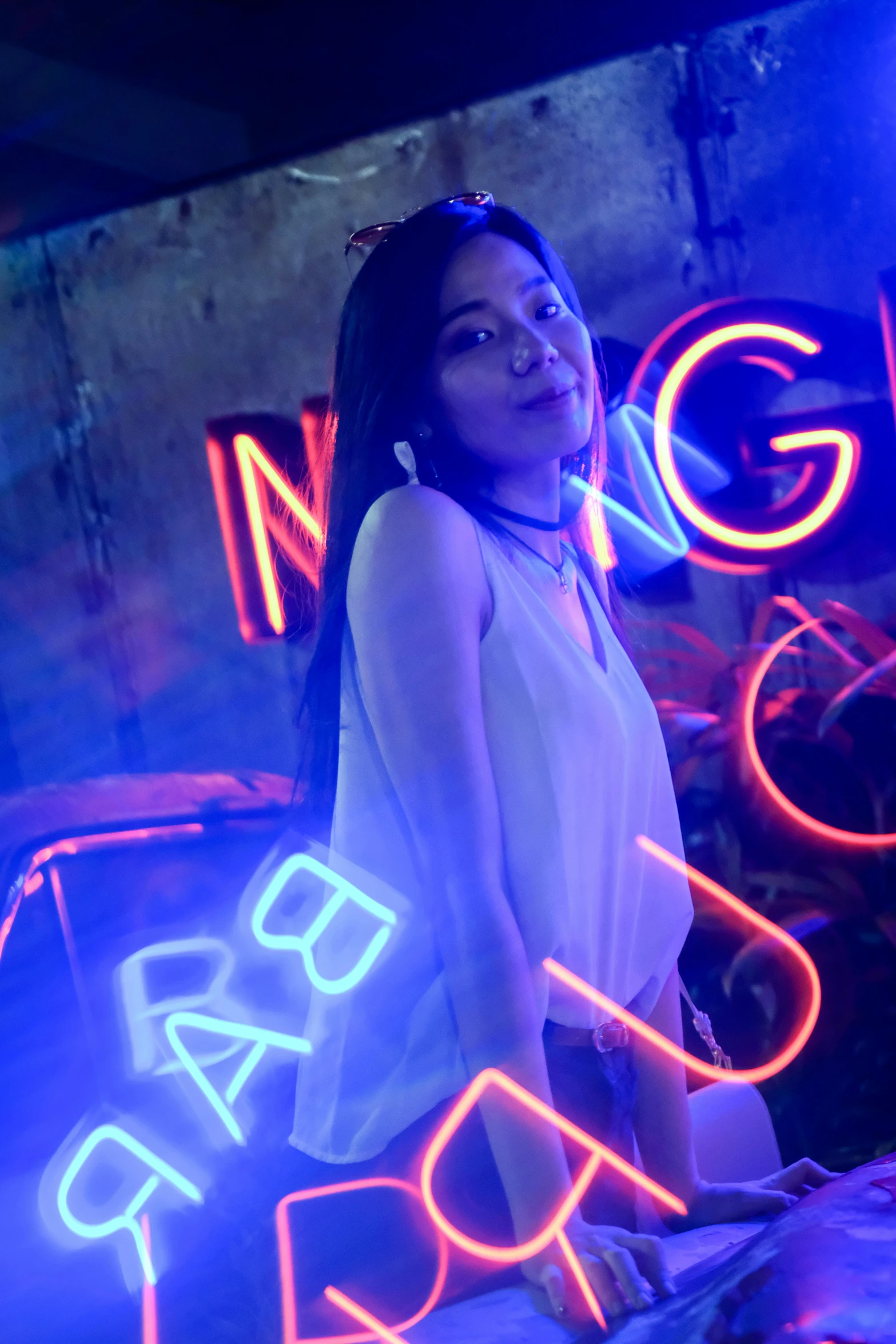 a woman is standing with neon signs
