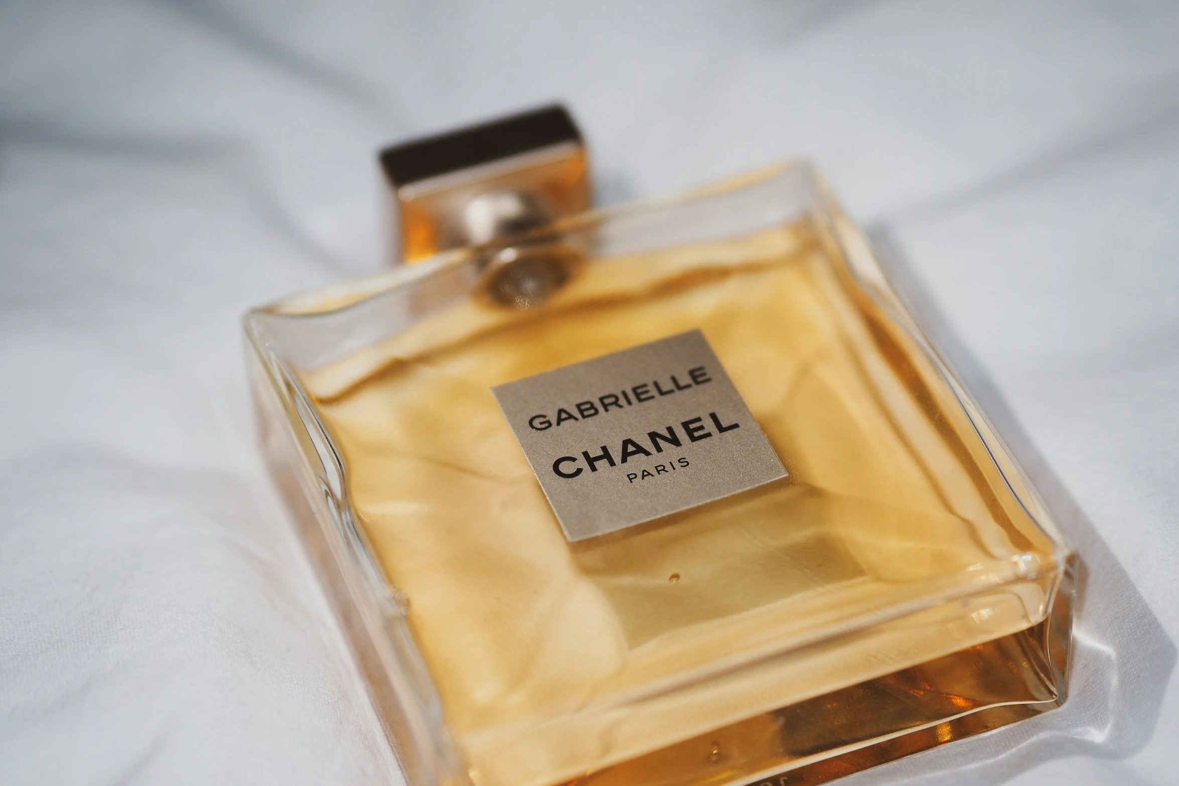 a bottle of perfume with a tag that reads cariele chanel