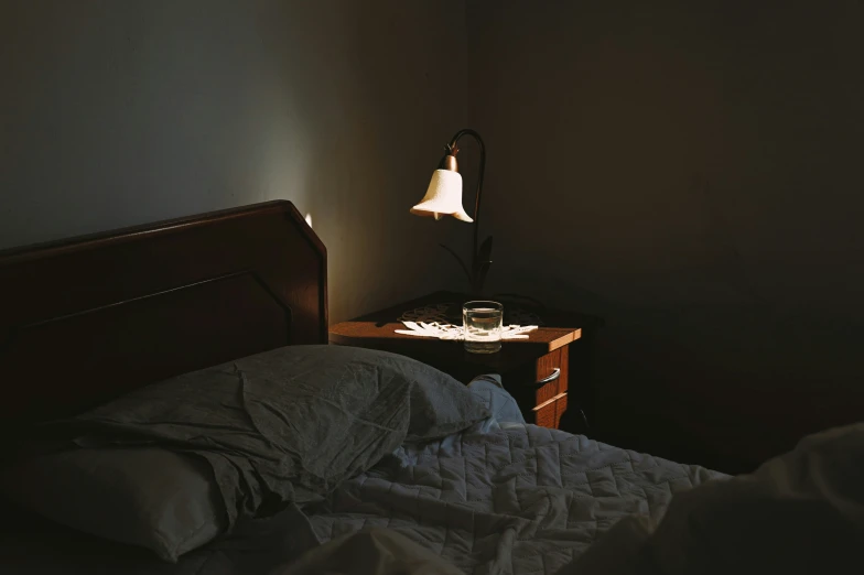 an empty bed in a dimly lit room