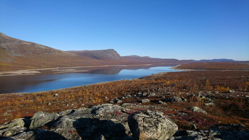 a view looking down on an area with hills and a lake