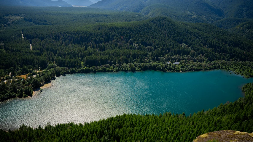 the view from a hilltop of a large lake and mountain