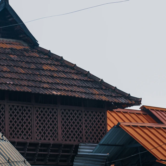 old tiled roofs stand against an overcast sky