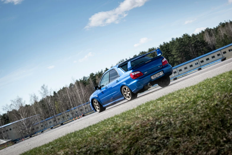 a blue car parked on the side of a road