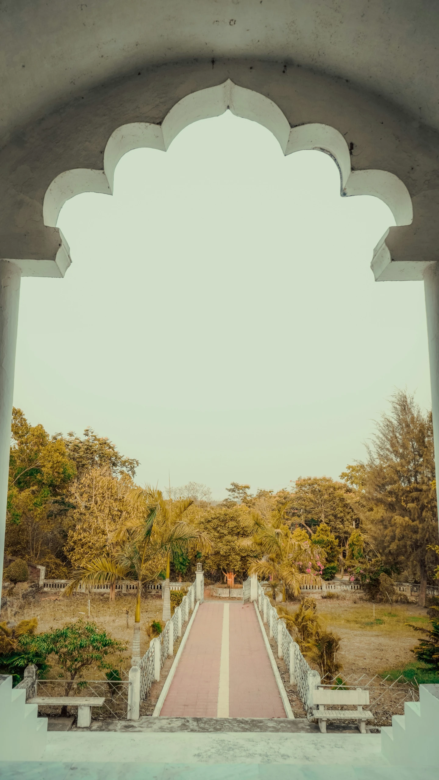 an arched walkway leading to a park area