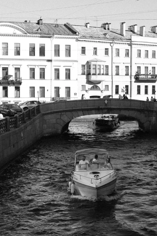 a small boat on the water near some buildings