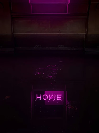 purple neon signage in dark lit building on concrete
