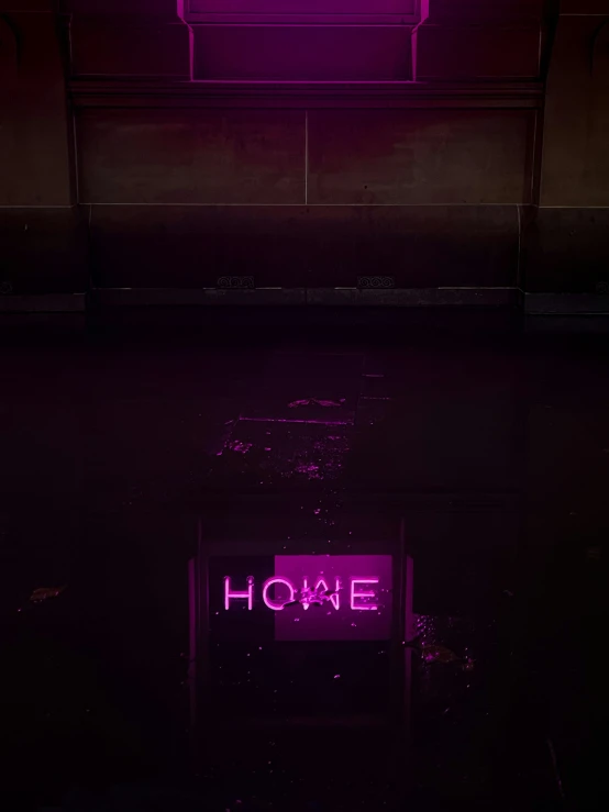 purple neon signage in dark lit building on concrete