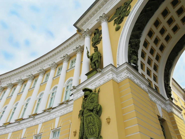 the top portion of a building with statues on it