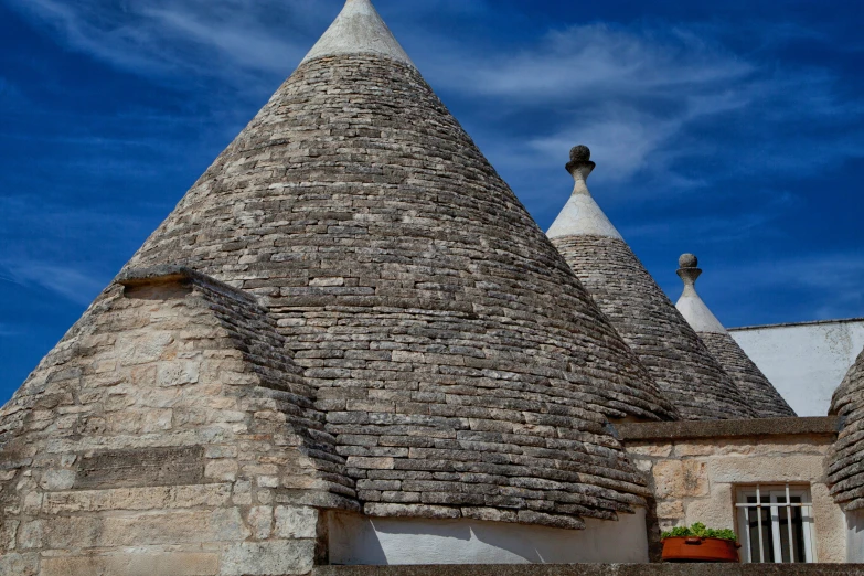 a white building with two conical towers against a blue sky