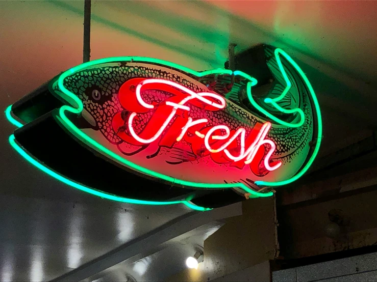 a large neon sign that says fresh on the front of a restaurant