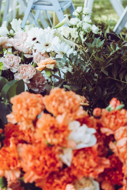 large bunch of flowers, two chairs behind them