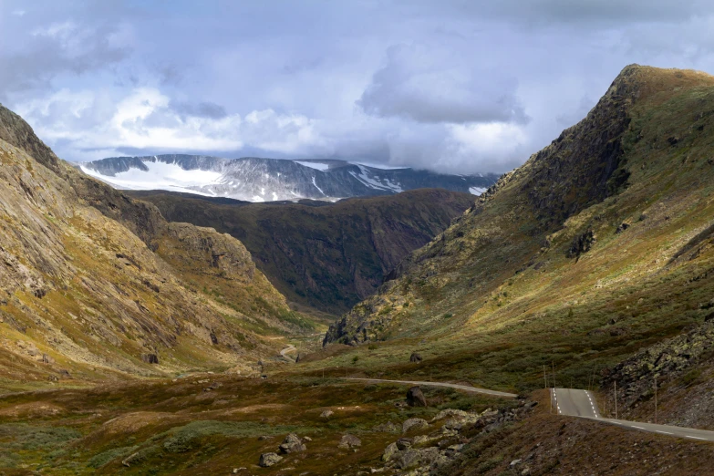 the view of some mountain side with snow on the mountains