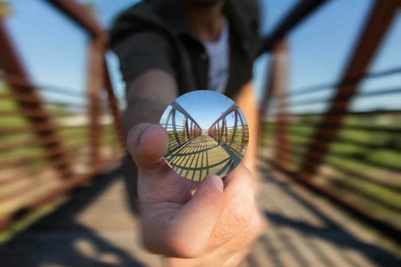 a blurry pograph shows a person holding up a circular object