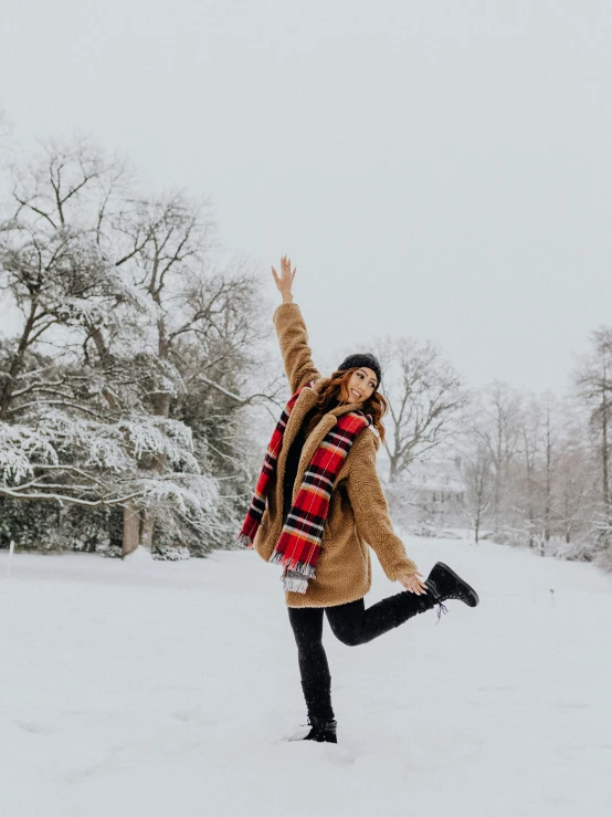 a woman who is jumping in the snow