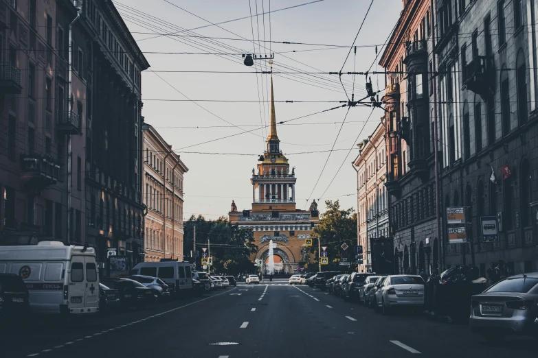 a narrow street in a city filled with cars