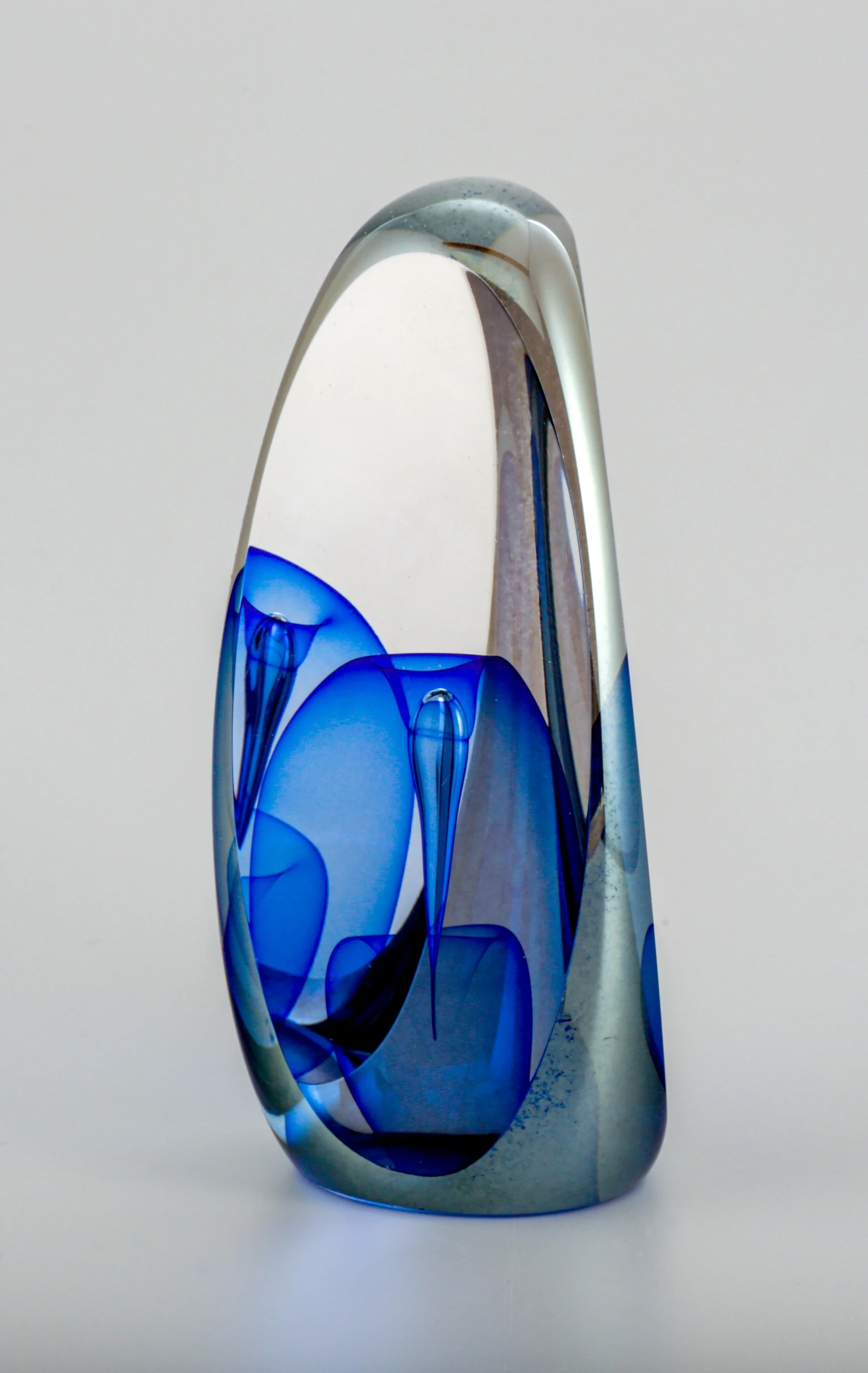 a unique blue vase is on display on a table