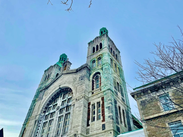 an old building with an odd tower next to a tree