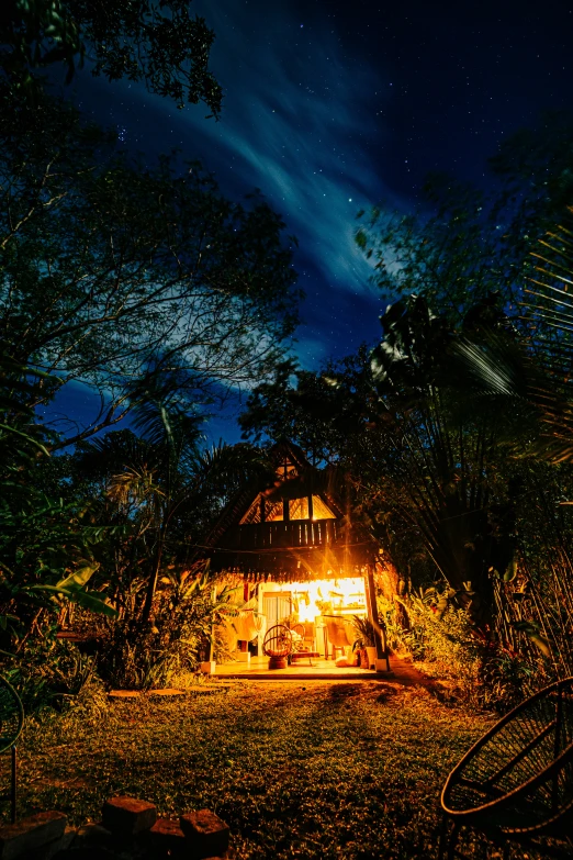 the back of a house at night, lit by a bicycle