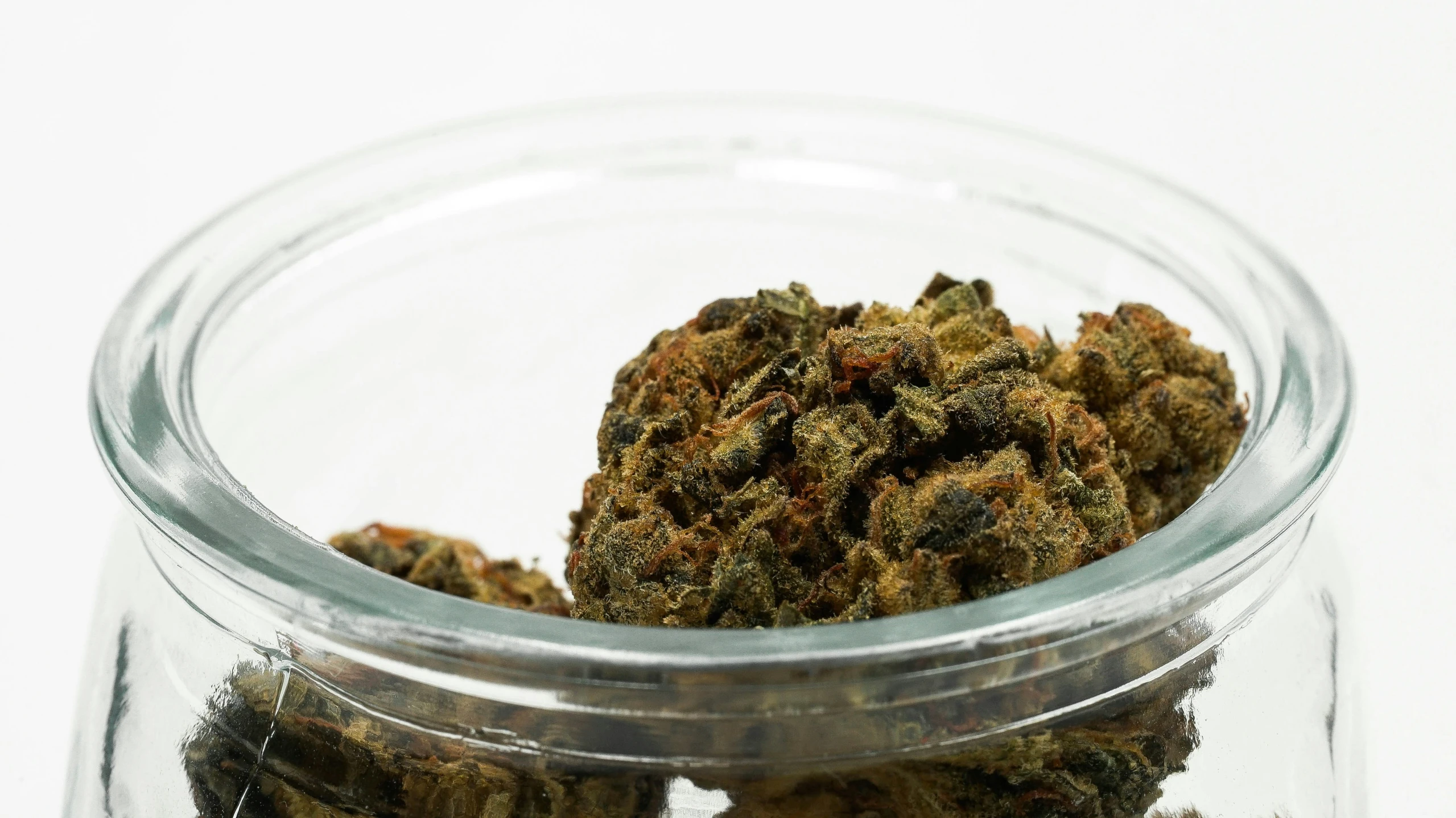 a glass jar full of different kinds of cannabis