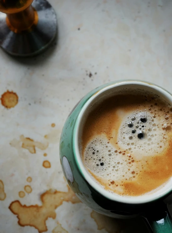 a cup of coffee on a table with a saucer