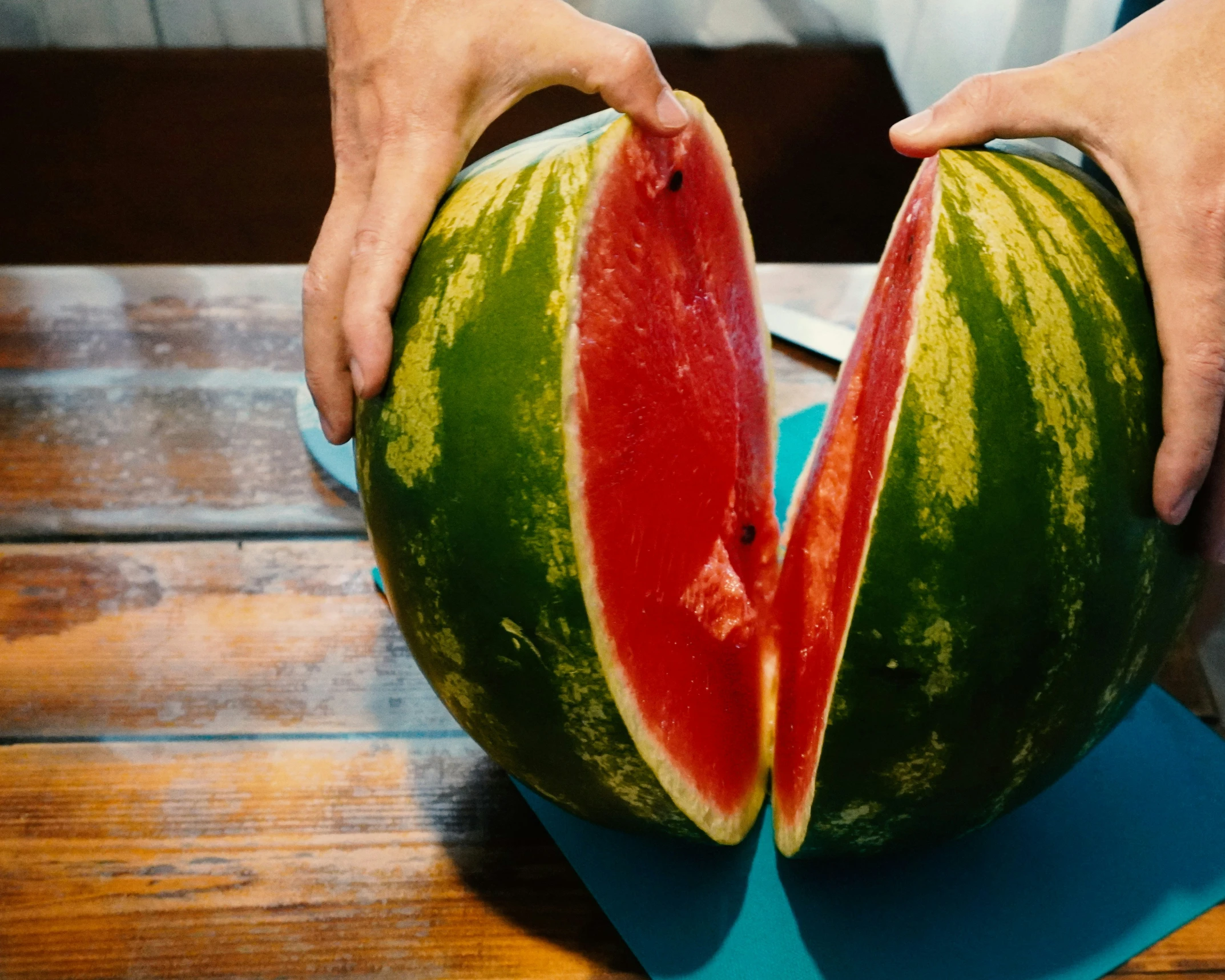 someone is  into a large slice of watermelon