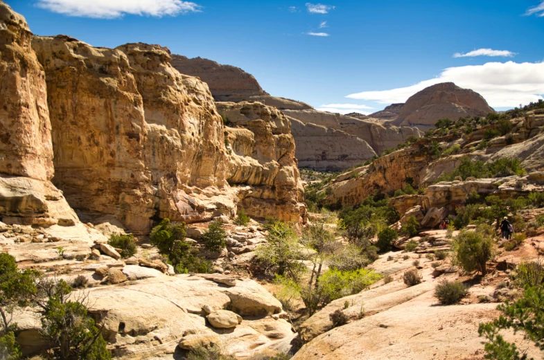 a rocky, steep river surrounded by hills and trees