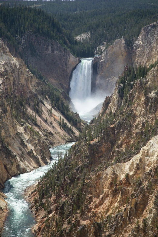 a big river running through a lush green hillside