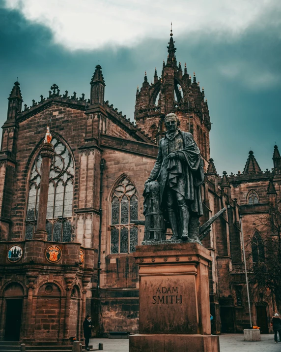 a statue sitting in front of a brick building