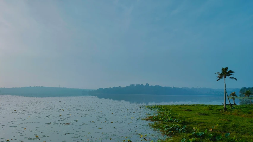 a calm lake with a lonely boat at the end of the line