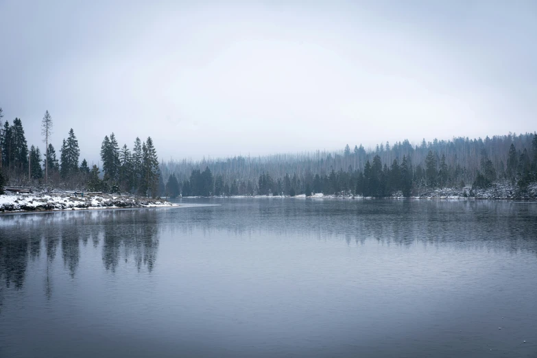 a snowy mountain lake surrounded by trees