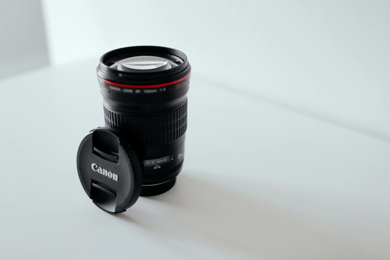 a canon camera lens cup sitting on top of a white table