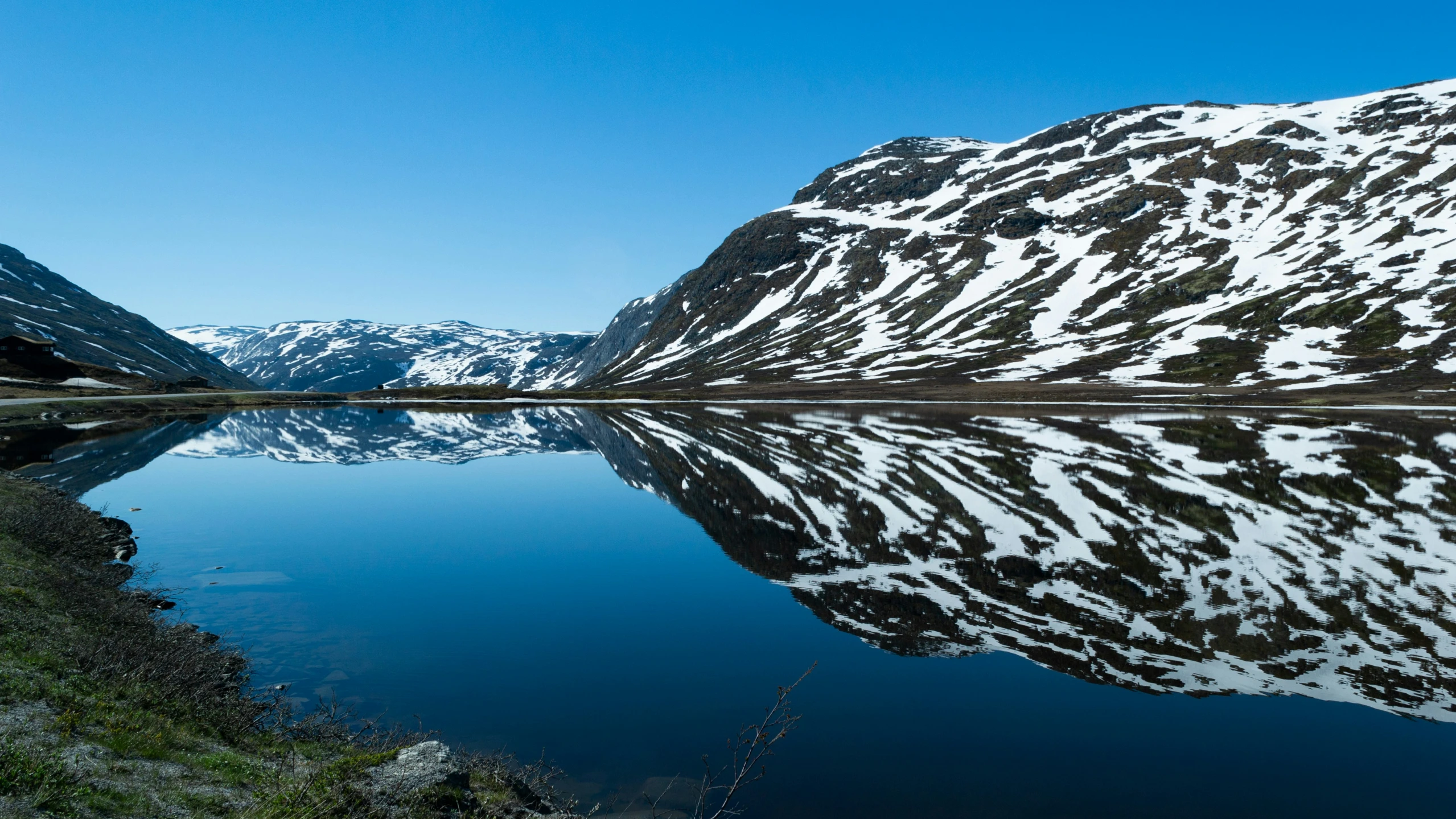 the snowy mountain is shown next to the water