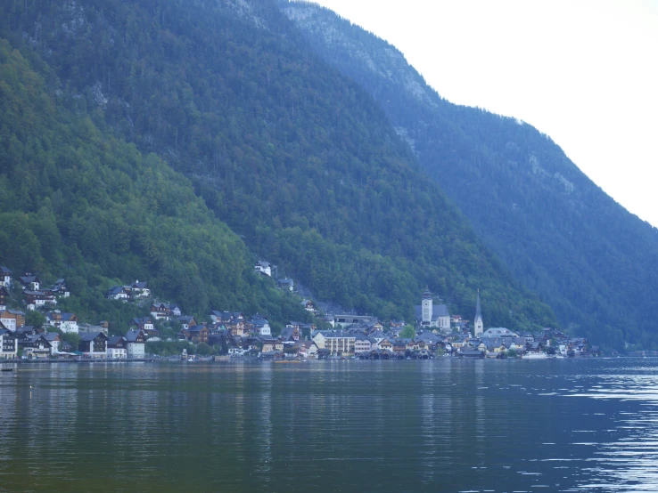 a view of a large body of water next to a hillside