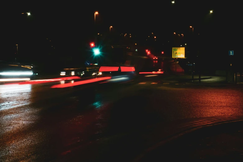 this street appears dark with car and bus traffic