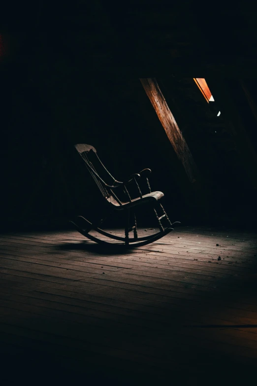 a chair sits on a dark room floor