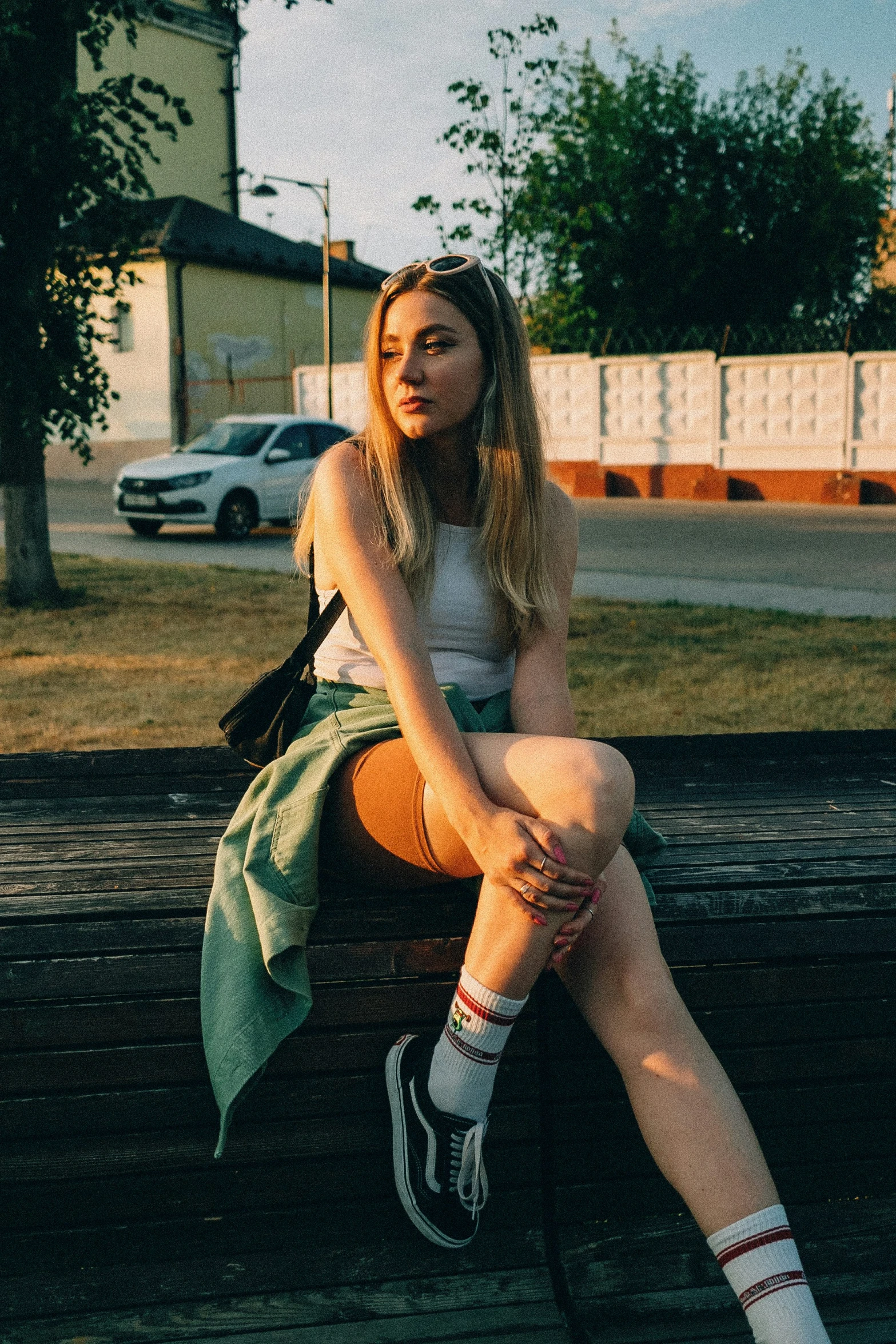 the woman is sitting on a park bench