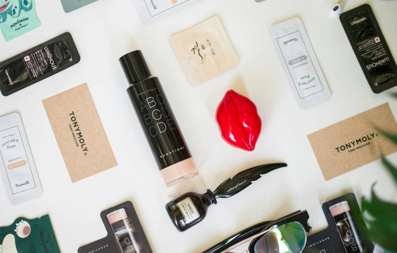 a display of various beauty products displayed on top of a white board