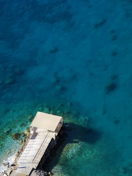 there is a dock and clear blue water