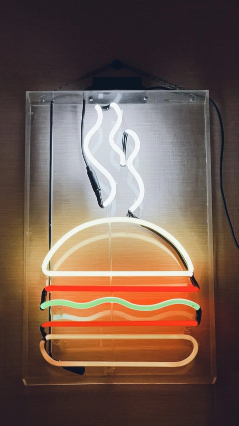 a lighted neon sign with a large sandwich in the middle