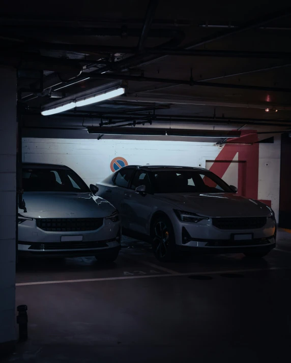 two cars are parked in a parking garage