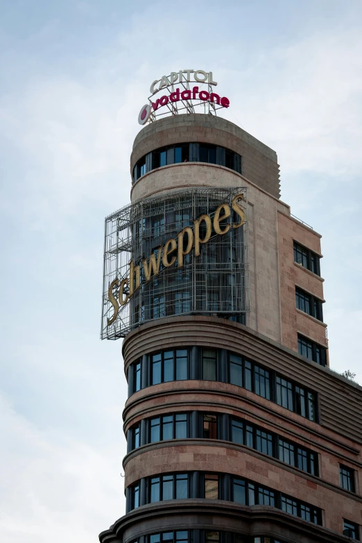 an exterior view of a building with a sign and a sky background